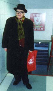 Picture of the Elvis Costello by the 'This is Anfield' Sign